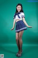 A woman in a sailor outfit posing for a picture.